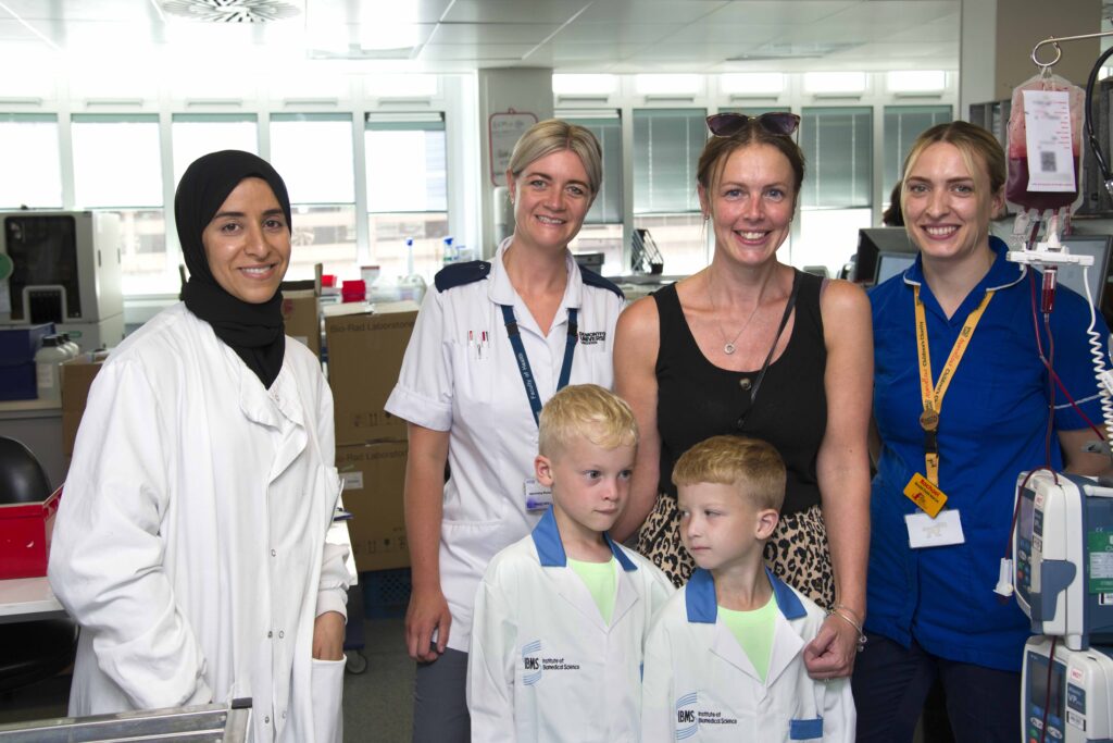 Image of colleagues from blood transfusion laboratory at the Leicester Royal Infirmary with Roco, his twin brother Frankie and mom Vicky