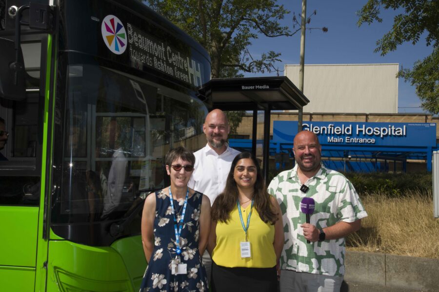 Ruth Ward, Ady Dayman, Bruno Marski, Bijel Mistry in front of a Hospital Hopper bus