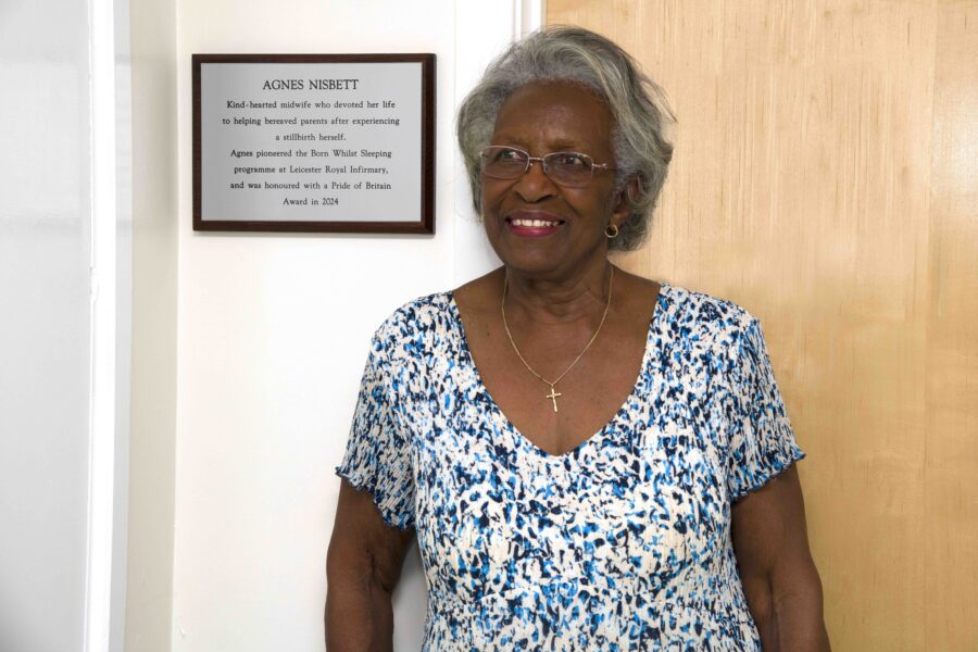 Agnes Nisbett in front of the plaque