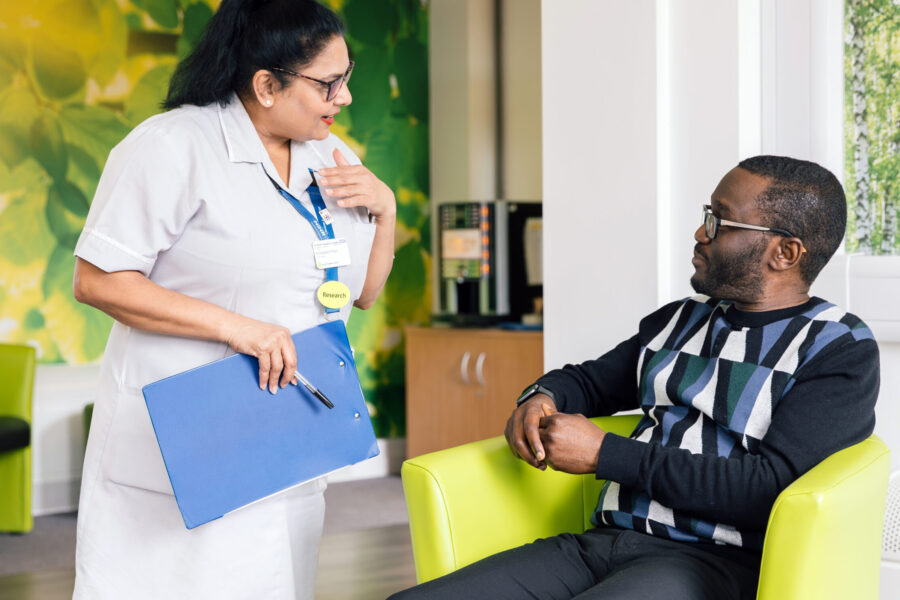 A Research Healthcare Assistant (HCA) talking to a participant at the CRDC.