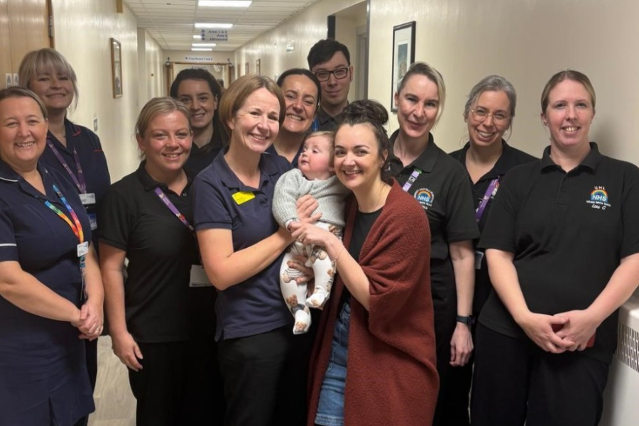 Image of group of midwives with a mother and child