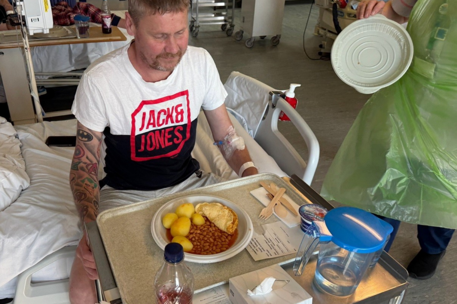 Patient Paul receiving a meal on the ward