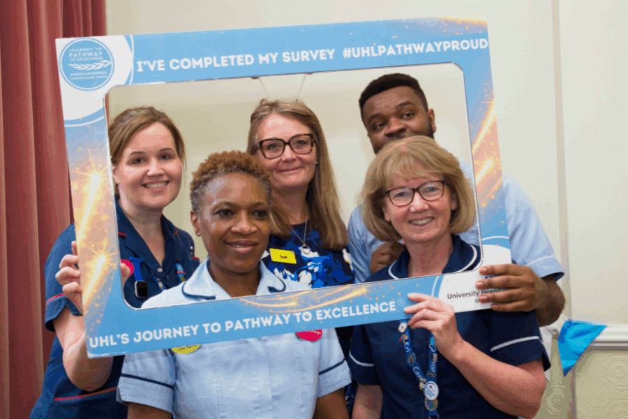 A group of colleagues from university hospitals of leicester celebrating their pathway to excellence accreditation